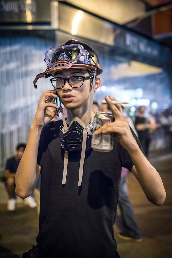 A young protester equipped with a mask