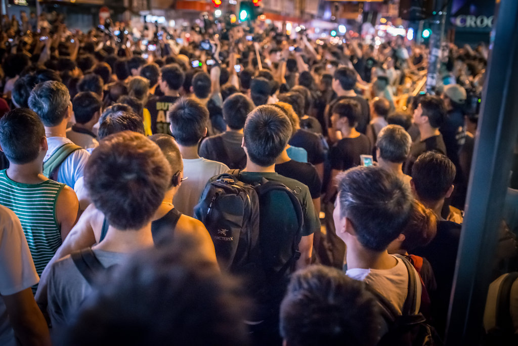 Crowd stares at an argument at Occupy Central