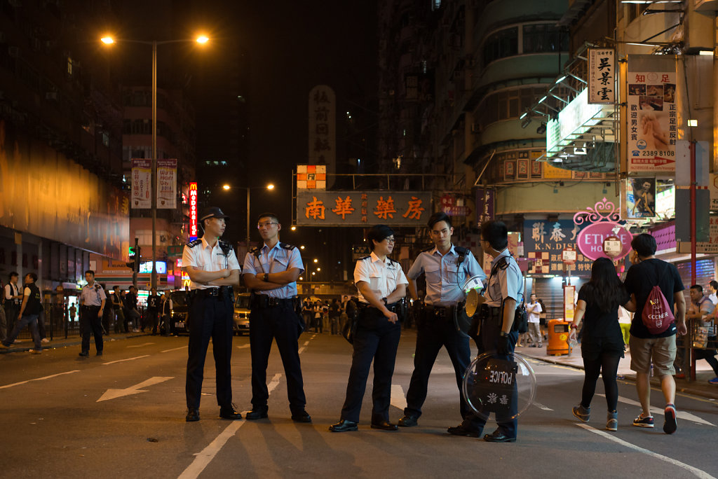 Police officers stand by close to the occupied streets